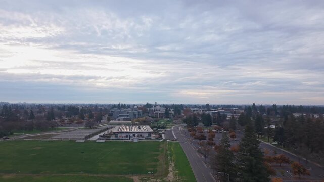 An aerial view captures CSU Stanislaus in Turlock during a cloudy dusk, with muted tones, campus rooftops, and winding walkways creating a calm academic atmosphere.
