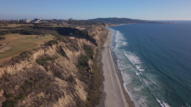Torrey Pines glider port. View of paraglider flying over the coastline.