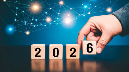 A digital marketing and technology-themed image showing wooden blocks with numbers 2026 arranged on a reflective dark surfac