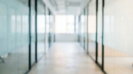 Bright blurred office background with glass walls and desks in modern coworking space for business presentation or digital design use with background