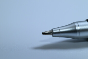 Close up of a silver ballpoint pen tip on white background