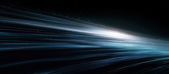 Streaking blue and white light trails with small particles against dark background