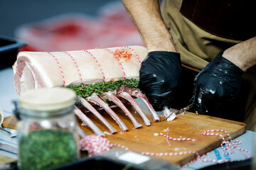 Details with the hands of a chef cooking pork ribs