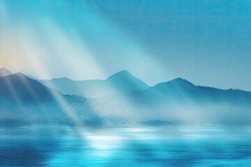 Serene blue mountains shrouded in mist under ethereal light beams