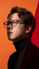Fototapeta premium Asian man in glasses looking up with hope