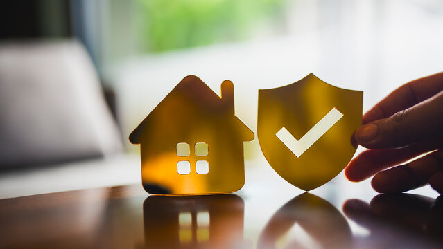 Home insurance and property protection concept with house icon and shield with check mark. Symbol of safety, security, risk management, insurance coverage, real estate protection, and trust.