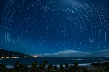 Amazing silky seawater,verdant coastal hills,blue startrail sky, white clouds form a dreamy scenery...