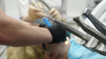 Modern dentistry. Dental Veneers: Porcelain Veneer installation Procedure. Dentist preparing teeth for installing zirconia veneers and crowns using dental bur. Dentistry, prosthetics. orthopedist