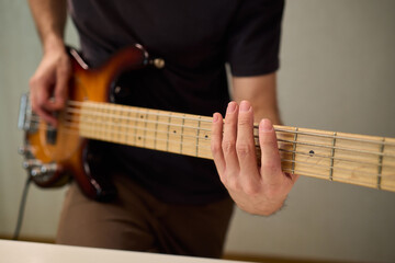 Musician working in cozy studio, Casual musician practicing bass with effects and accents, Relaxed...