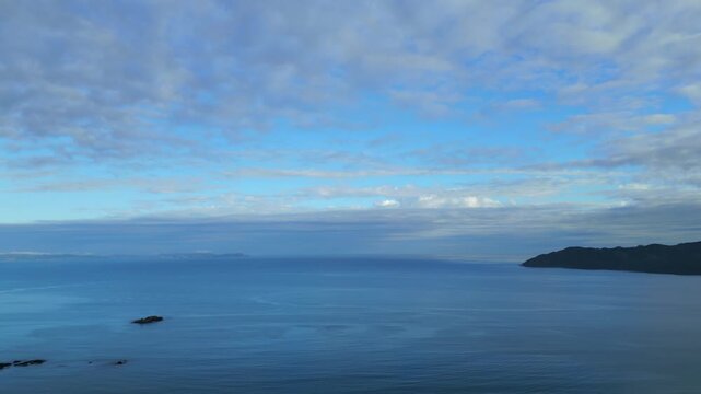 Aerial establishing overview of Coopers Beach Bay North Island New Zealand with current water textures
