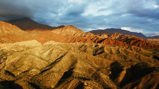 Layered hills and eroded ridges define Fiambala high desert landscape beneath wide open sky