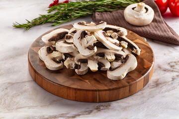 Fototapeta premium Raw champignon slices on the board