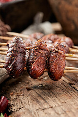 Charcoal-grilled silkworm pupae