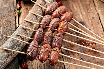 Charcoal-grilled silkworm pupae