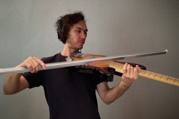 Powerful bass performance, Dynamic performer passionately communicating through bass guitar, Musician with curly hair immersed in expressive bass playing in studio environment