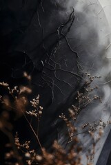 Macro view of dried flowers and fine branches against distressed dark gray textured wall