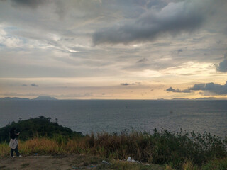 Beautiful sunset over the sea and the mountain in the background.