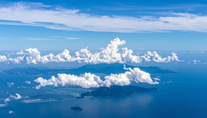 An aerial view of an island island surrounded by calm water under a cloudy sky.