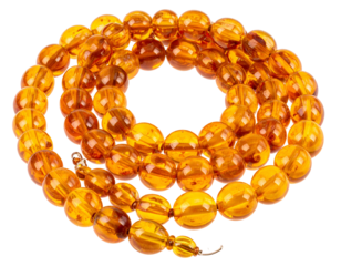 Close-up of a necklace made with rounded, translucent, amber beads