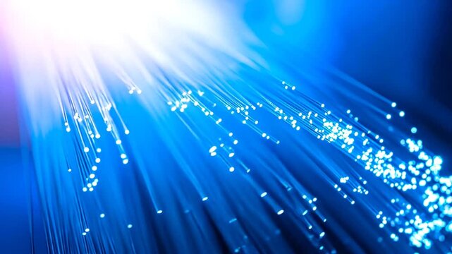 Glowing blue strands radiate light in a dark composition. A brilliant, bright area illuminates the image