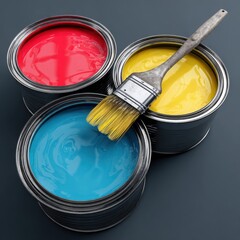 Open paint cans and brush with vibrant colors