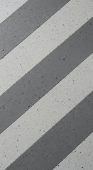 Diagonal alternating pattern of textured gray and light gray surface material creates a repeating background.