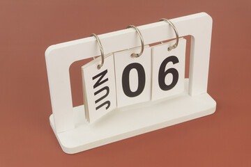 June 6 on calendar on brown background