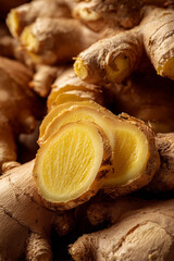 Fresh ginger root with sliced pieces revealing vibrant yellow interior