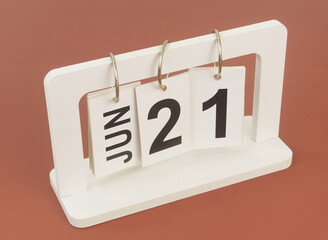 June 21 on calendar on brown background
