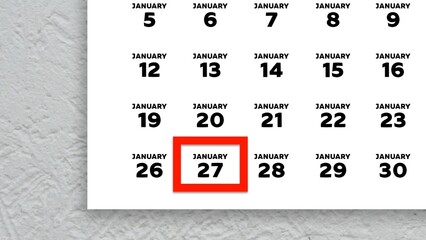 Close-up of the date January 27th marked with a red cursor on the wall calendar 2026
