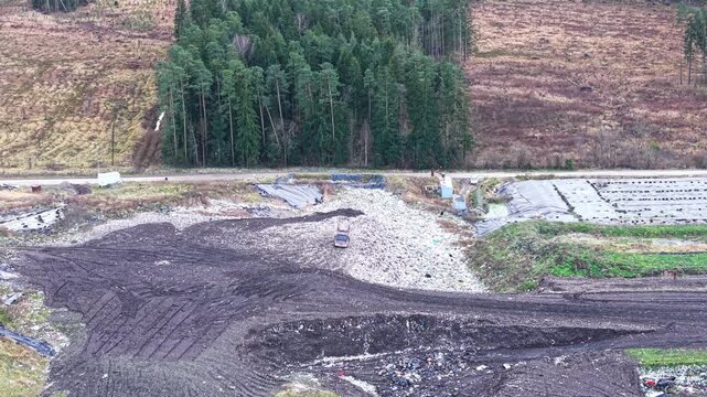 Drone medium approach to bulldozer across multiple landfill zones and surrounding natural buffer areas