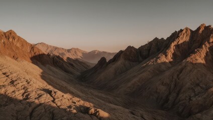 Fototapeta premium Rocky mountains, with valley fading to the horizon, lit by the setting sun