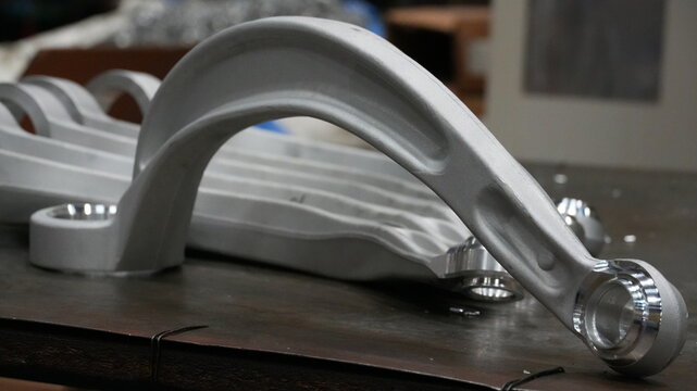 High-precision CNC machined metal parts and link arms for industrial and automotive manufacturing applications.