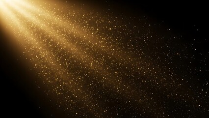 Gold particles falling from light beam on black background