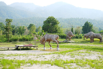 Animal straw sculptures made from woven straw on green grass at Huay Tung Tao Reservoir in Chiangmai of Thailand