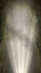 Spectacular Natural Light Rays Shining Through Thick Mist Inside a Deep Mossy Vertical Canyon