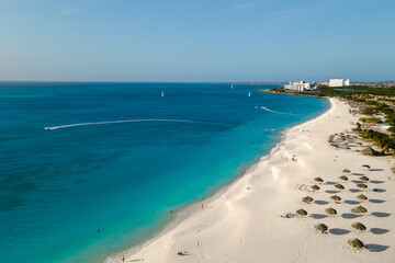 Soft white sand and vibrant turquoise waters create a breathtaking scene at Divi Beach in Oranjestad Aruba.