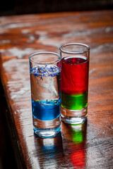 Two stunning drinks showcase vibrant colors and delicate flowers, basking in warm light