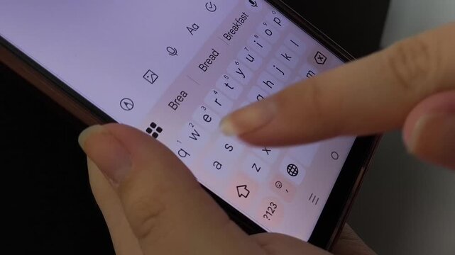 Close-up of female hands typing on phone keypad. Message, messengers. Correspondence with friends