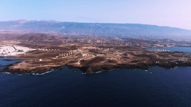 Coastal Tenerife view with Old Abades ruins and windmills in volcanic setting