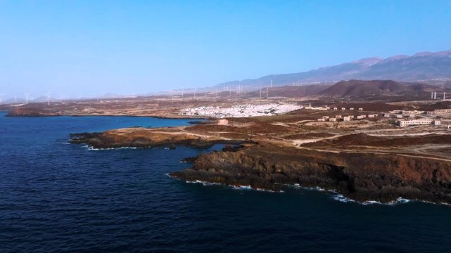Dawn at Arico coast with Abades and windmills in serene view