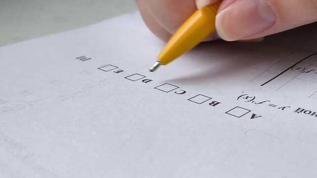 the student chooses the answer C in the exam and ticks the box. Exams at school, college, university.