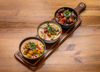 mix of traditional thai curries on restaurant table in phuket thailand