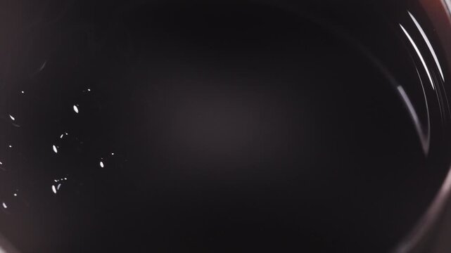 Black ferrofluid forms dynamic shapes in liquid, mesmerizing movement
