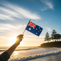 Australian flag waving on the beach at sunrise
