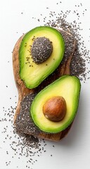 Two halves of avocados on a wooden board with chia seeds