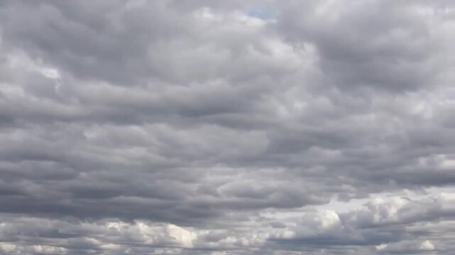 Dramatic 4K timelapse captures dark clouds overtaking the sky, highlighting intense weather changes, ominous atmosphere, and powerful storm dynamics
