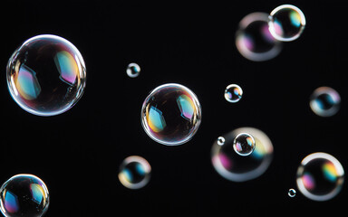 Group of Flying Soap Bubbles Isolated on Black Background © Visuals Stock