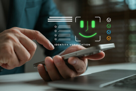Businessman using smartphone for identity verification with facial recognition interface, representing digital security, personal data protection, and secure access in modern technology. - Powered by Adobe