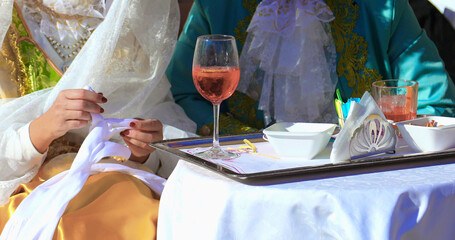 noble couple wearing old clothes from last century while drinking alcoholic spritz alfresco table